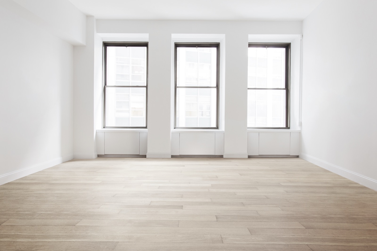 Bright apartment interior with new light wood-look flooring