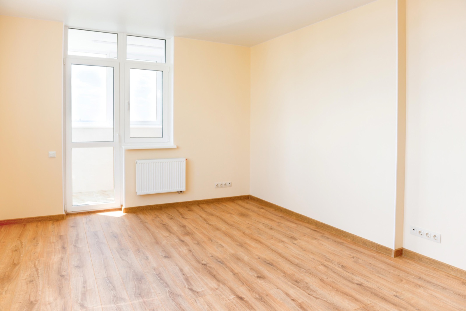 Empty, freshly turned rental room with wood floors ready for move-in