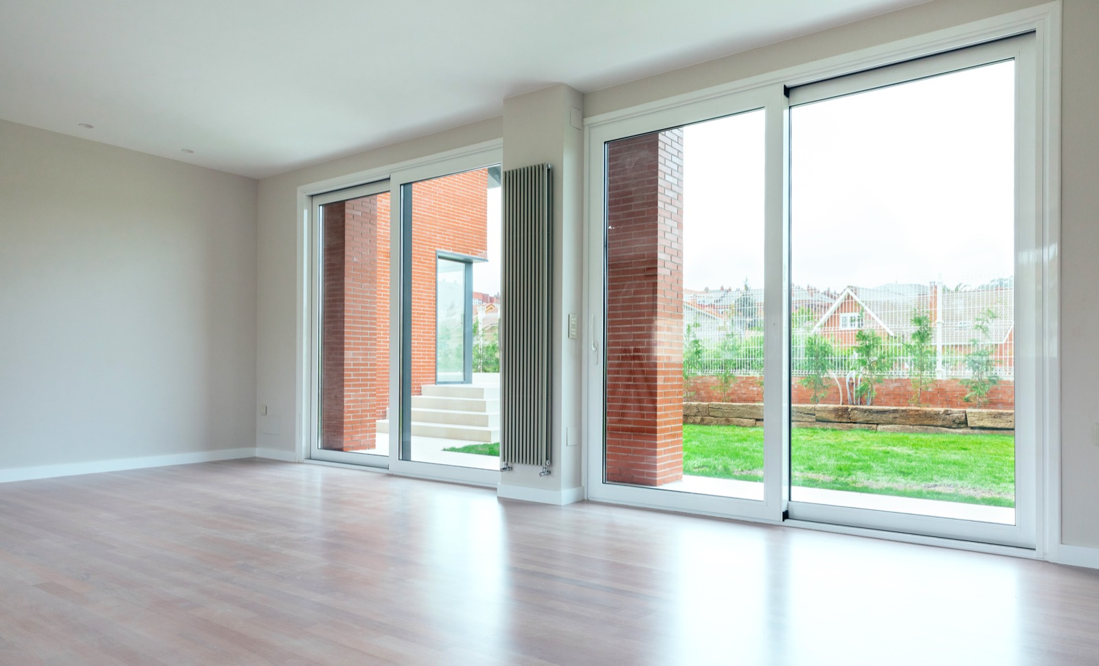 Tidy garden seen through a home's sliding glass doors