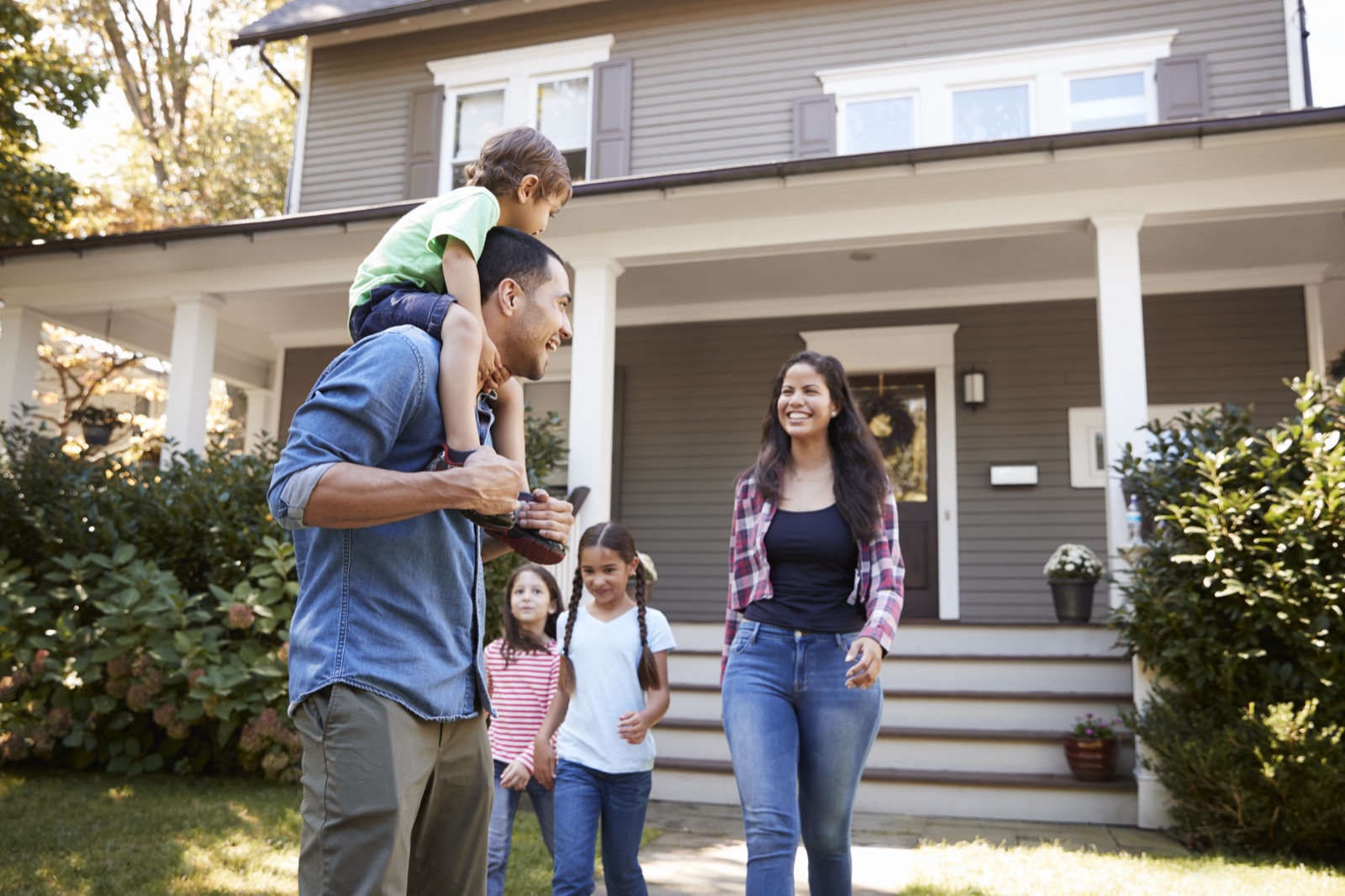 A happy DFW family outside their home