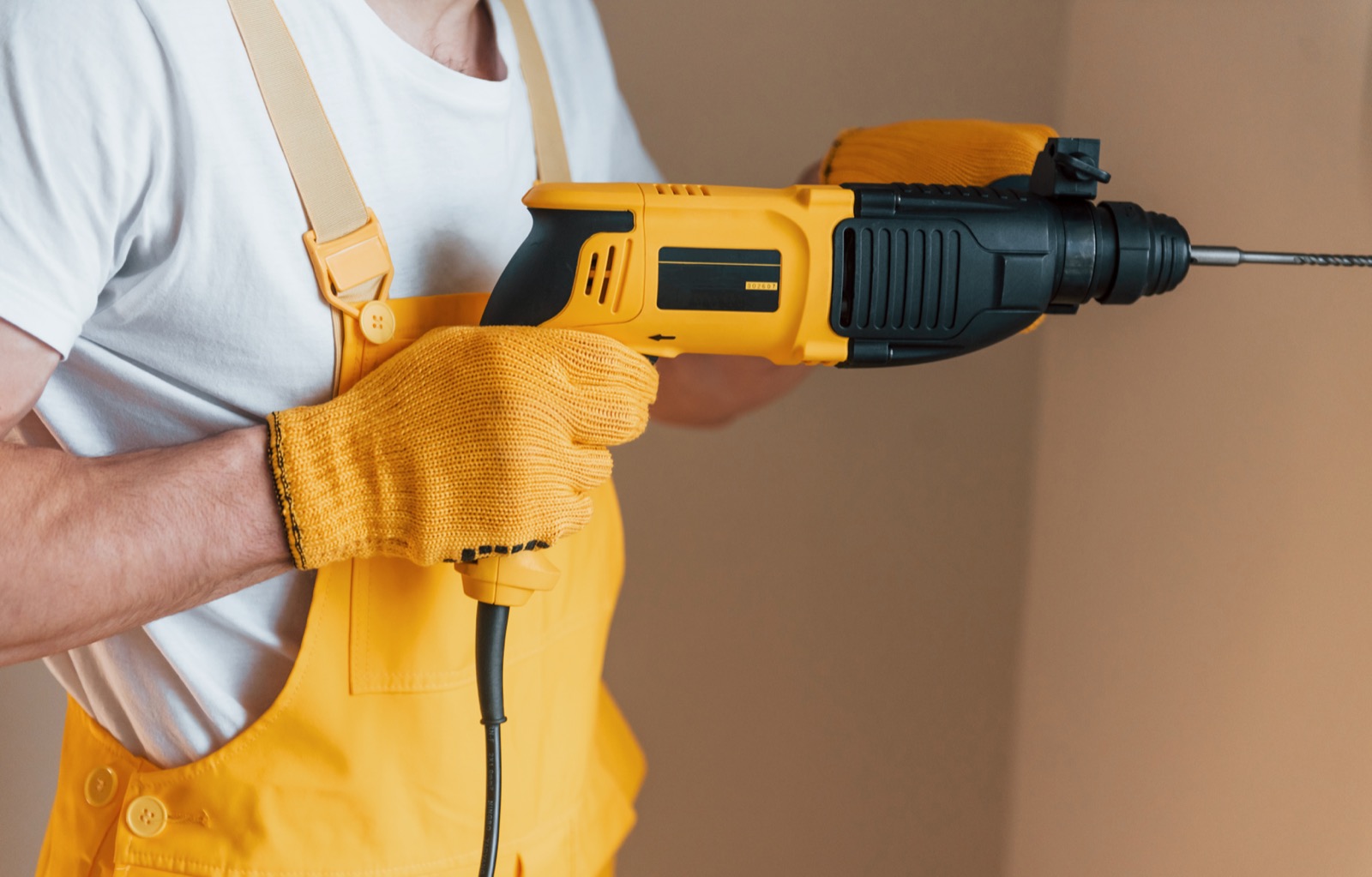 Maintenance technician in uniform working inside a home