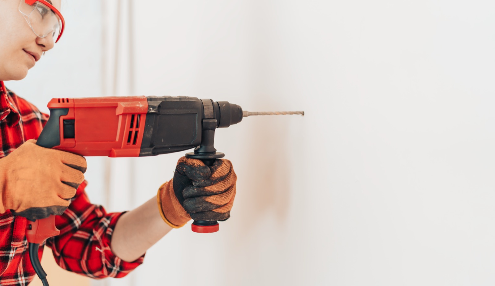 Handyman using a power drill during an appliance installation