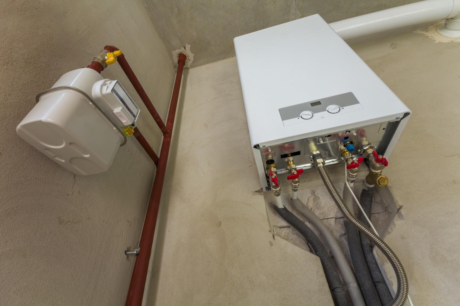 Wall-mounted tankless water heater installed in a home