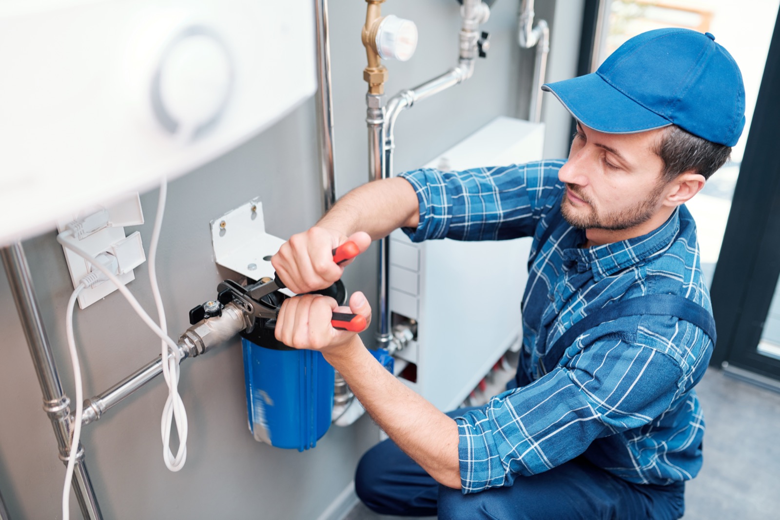 Plumber repairing pipe as part of a larger sewer line replacement project