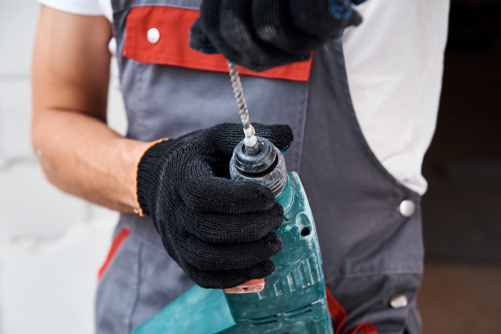 Worker using a power tool on an outdoor construction job