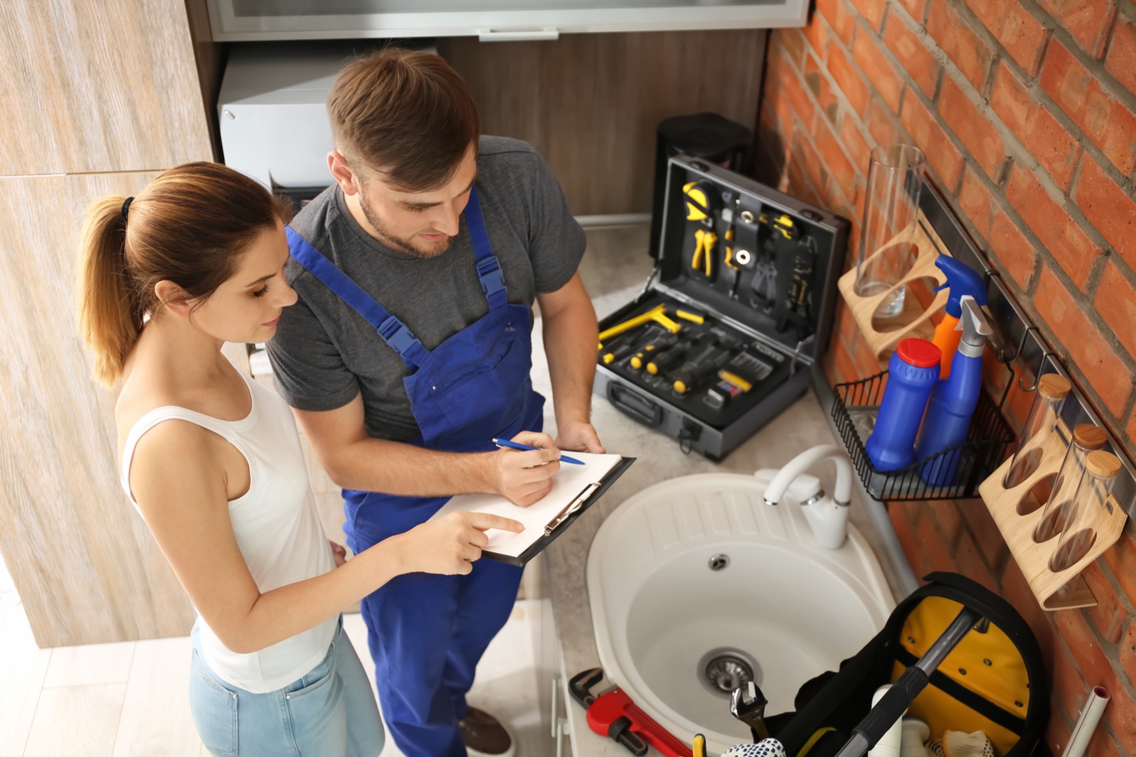 Professional plumber walking a homeowner through the job, honestly and clearly