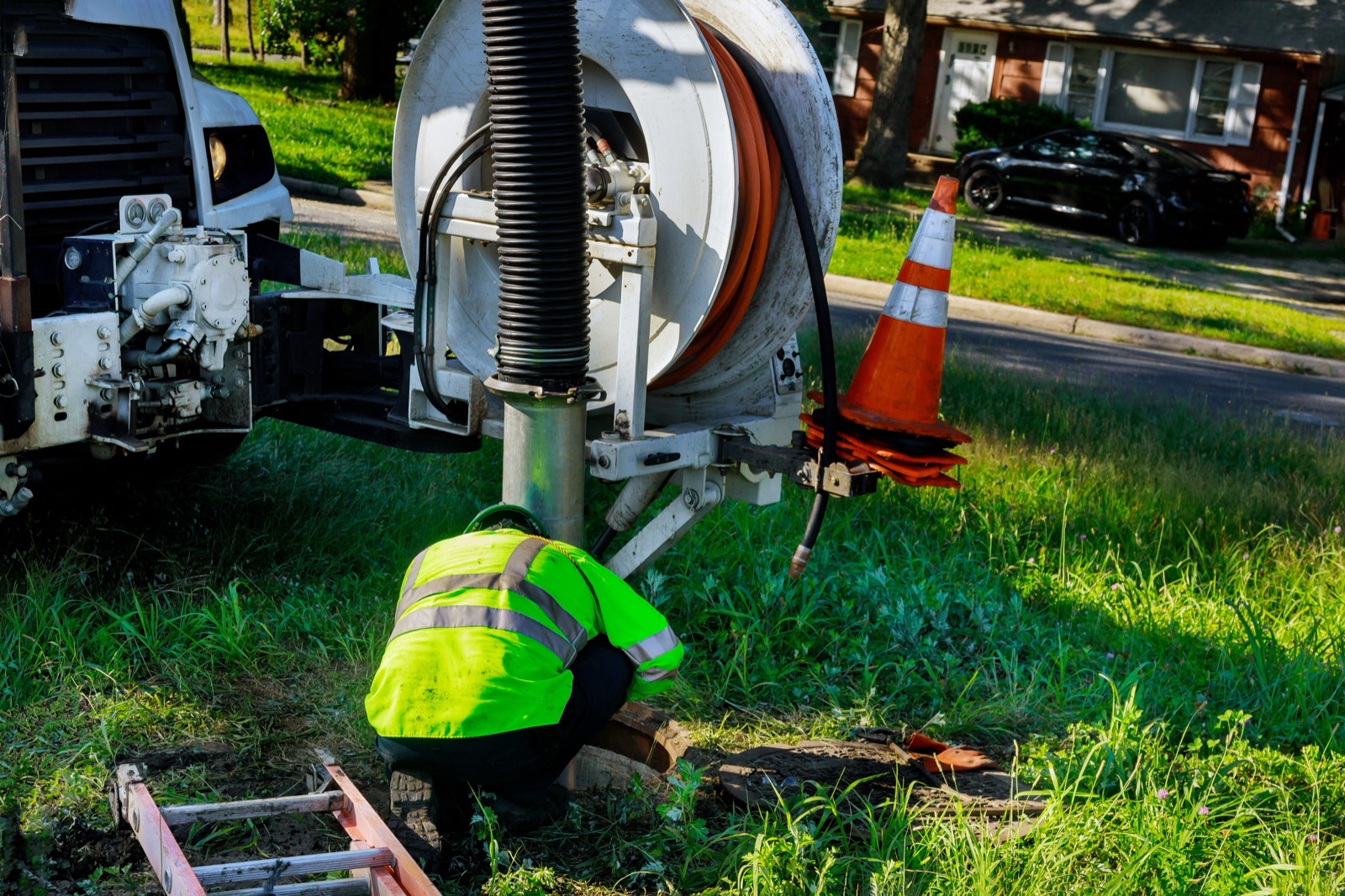 Sewer cleaning equipment staged over an open sewer access