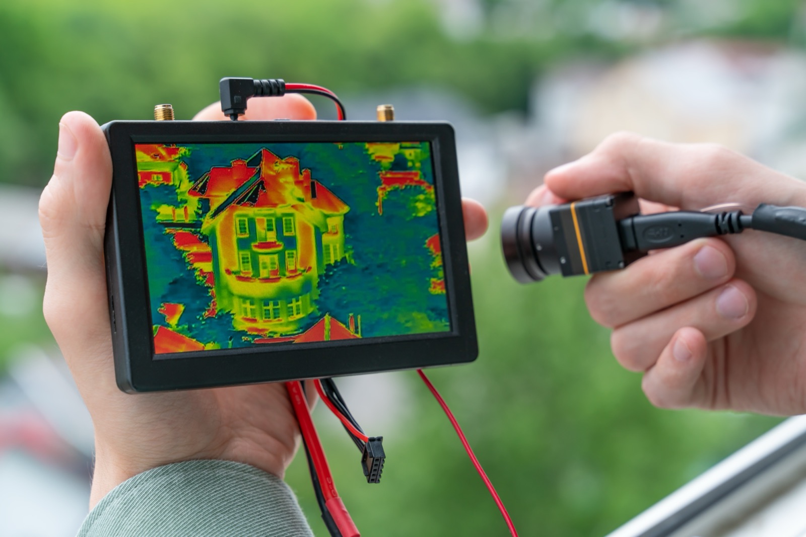 Thermal imaging camera scanning a wall to locate a hidden leak