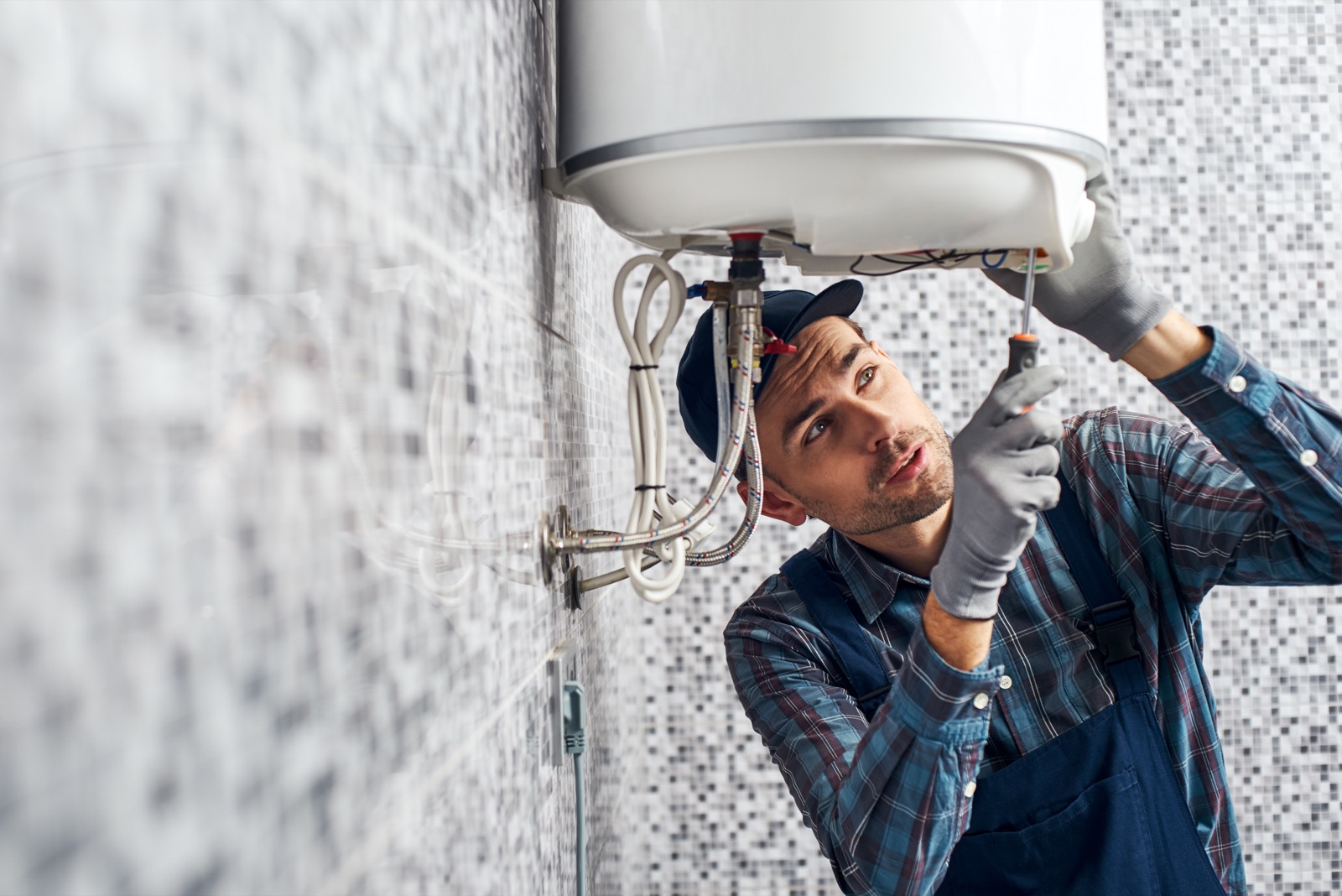 Skilled plumber repairing a residential water heater system